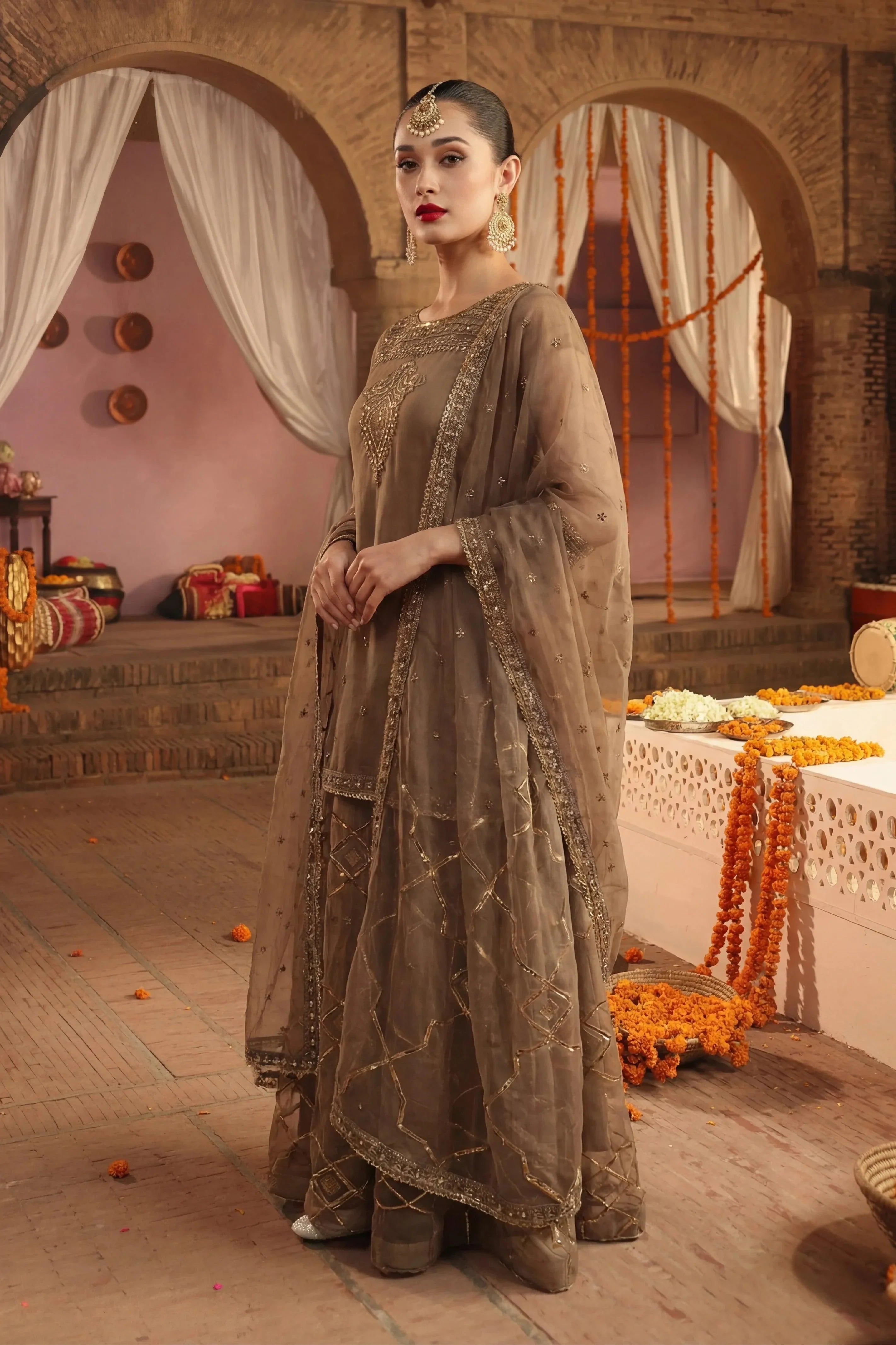 Elegant brown embroidered Pakistani dress with gold detailing, perfect for weddings and special occasions.