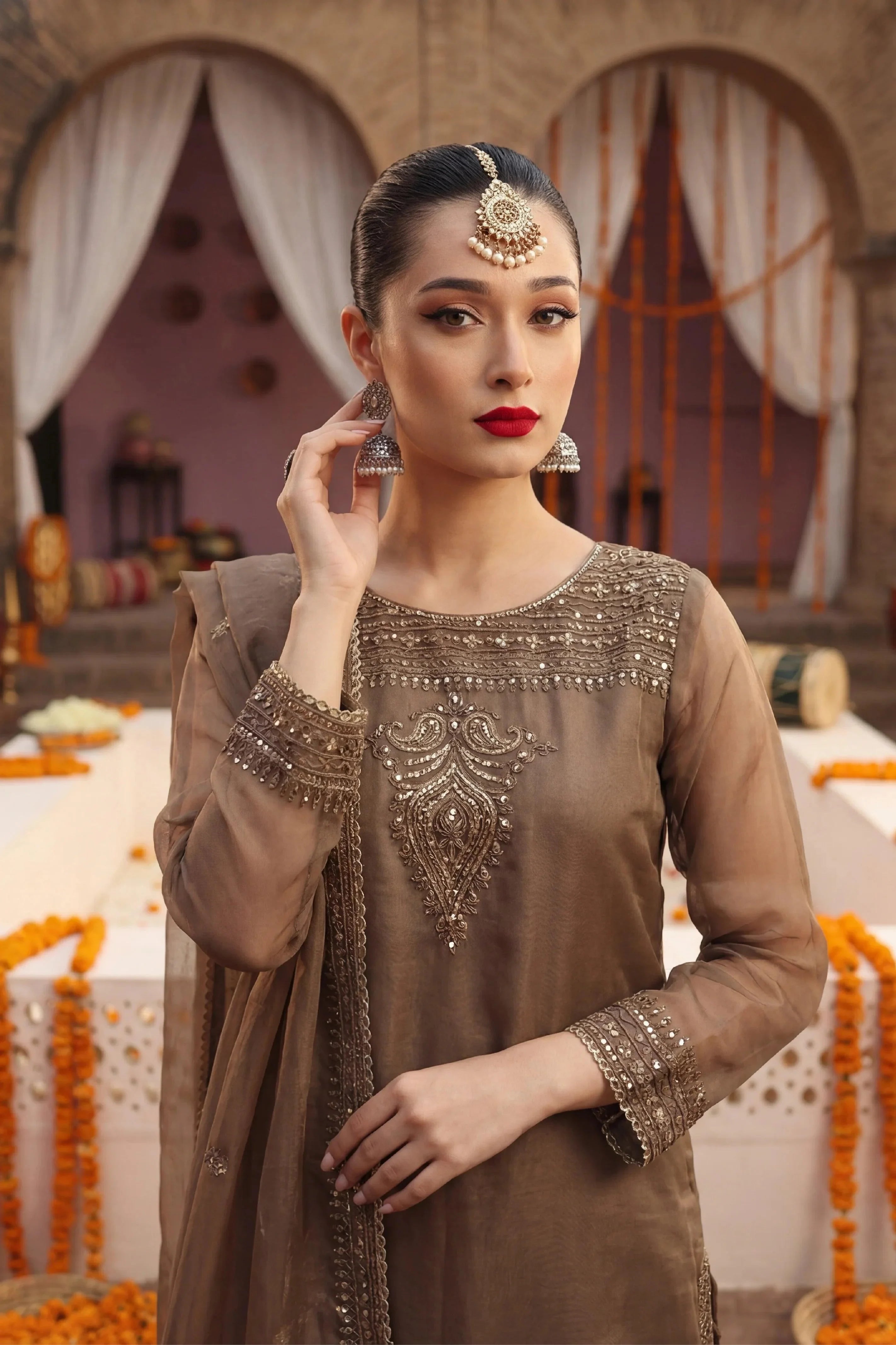 Elegant brown embroidered dress with gold detailing, perfect for Pakistani wedding or festive occasions.