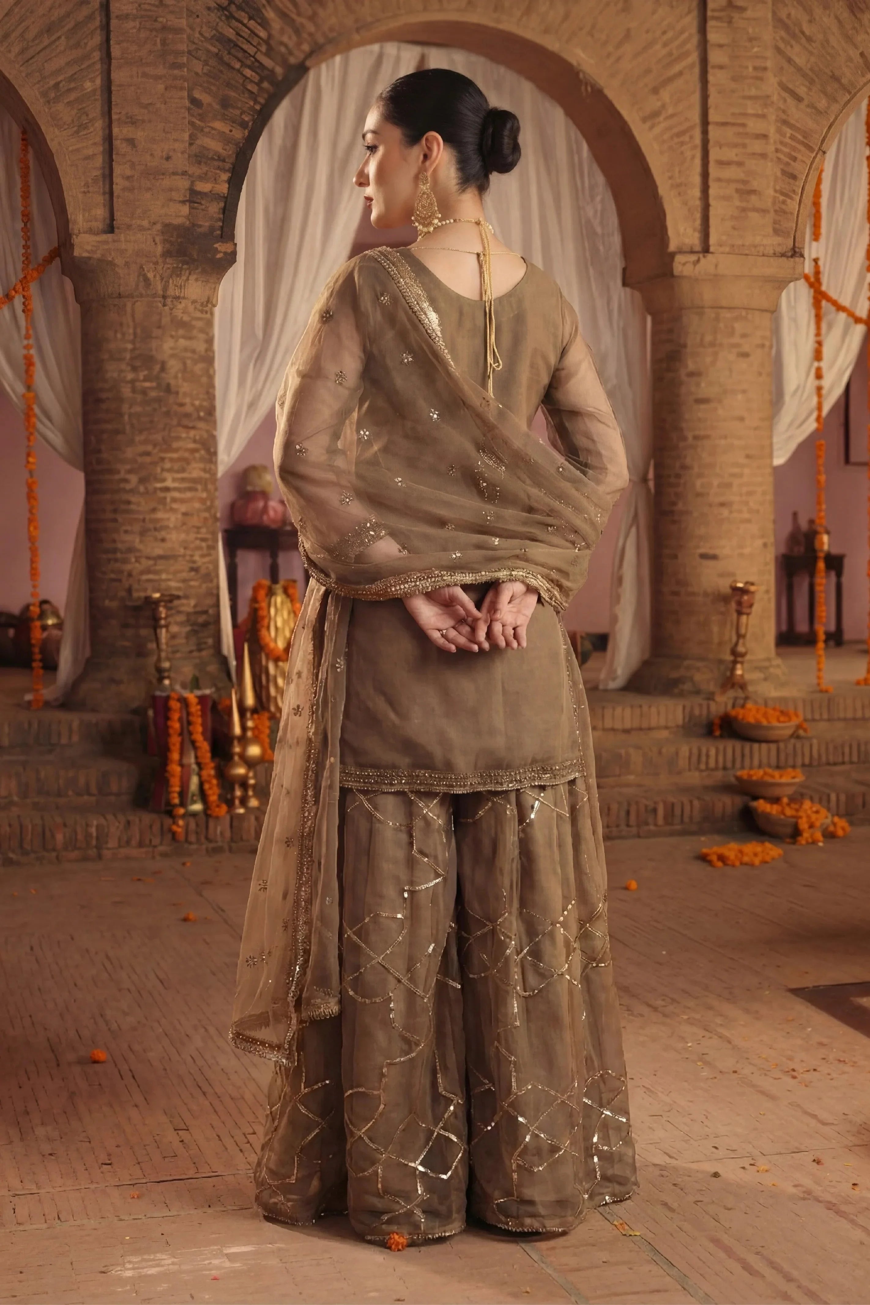 Elegant olive green embroidered Pakistani dress with gold detailing, perfect for weddings and special occasions.
