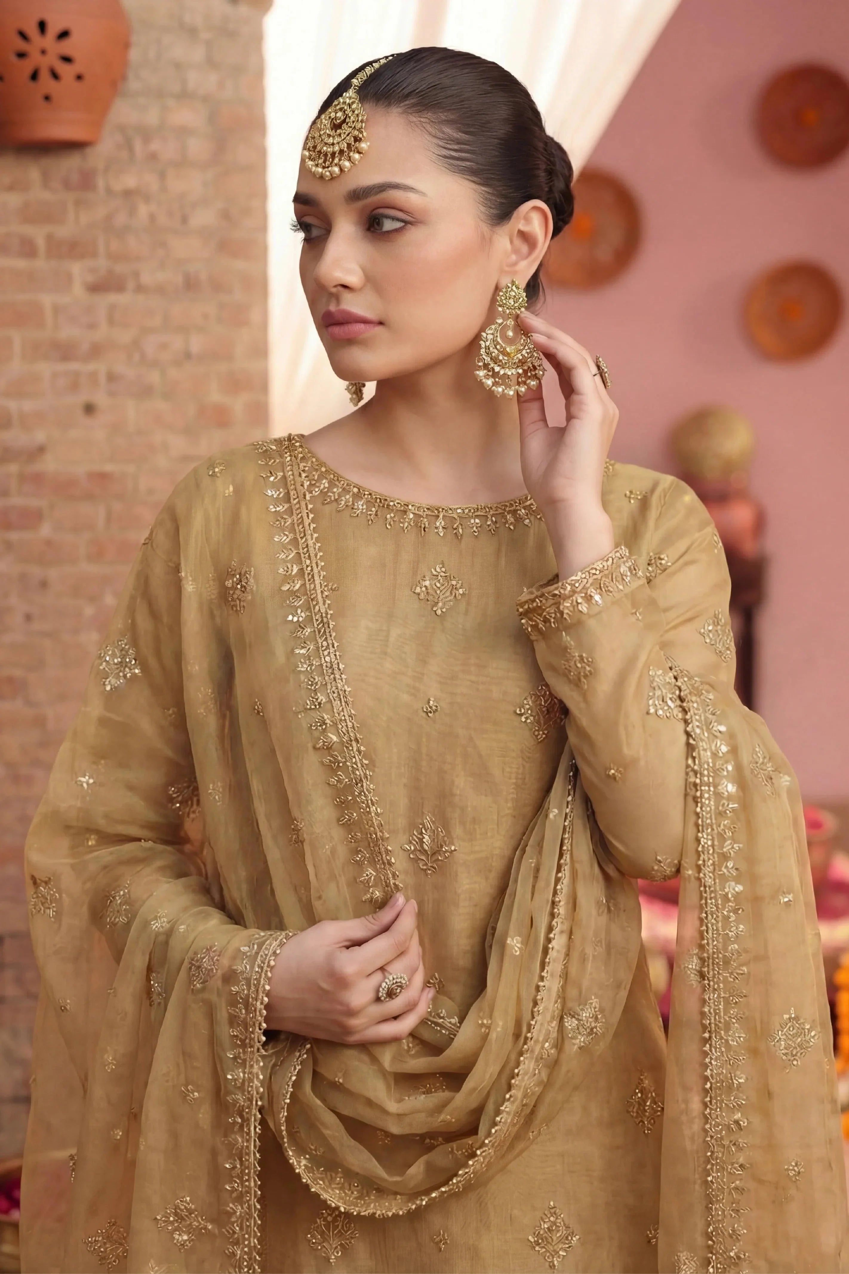 Elegant gold embroidered Pakistani dress with matching jewelry for special occasions