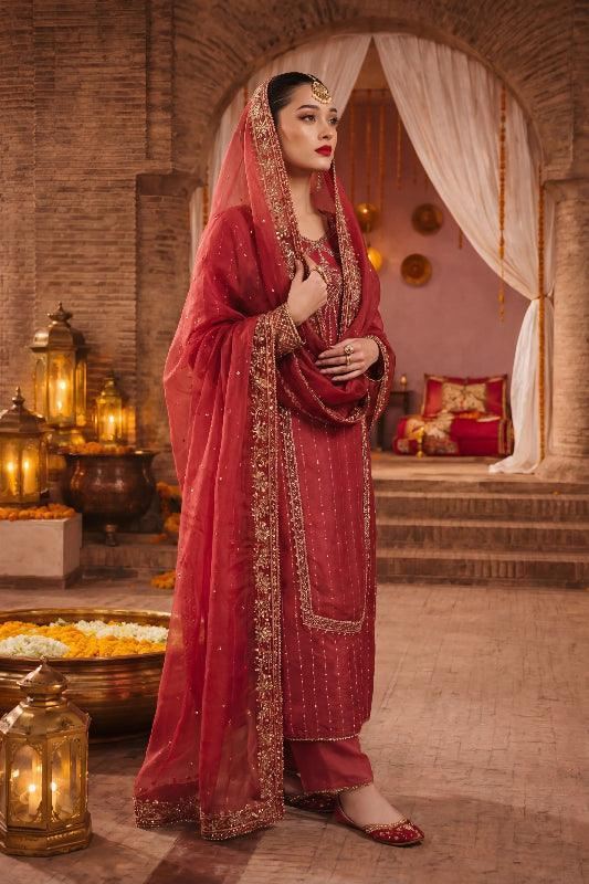 Elegant maroon Pakistani dress with gold embroidery, perfect for weddings and special occasions