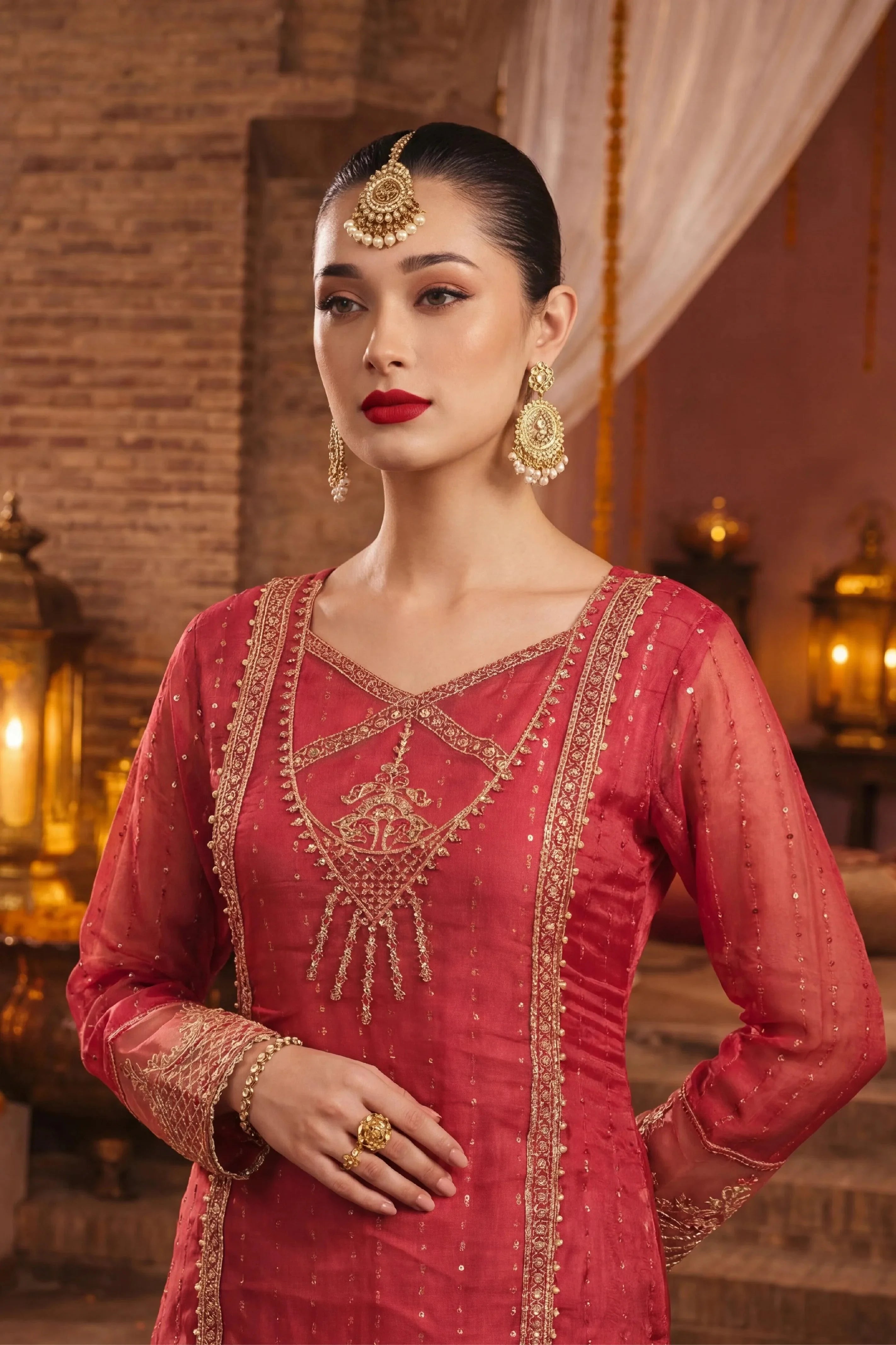 Elegant red Pakistani dress with gold embroidery, perfect for weddings and special occasions.