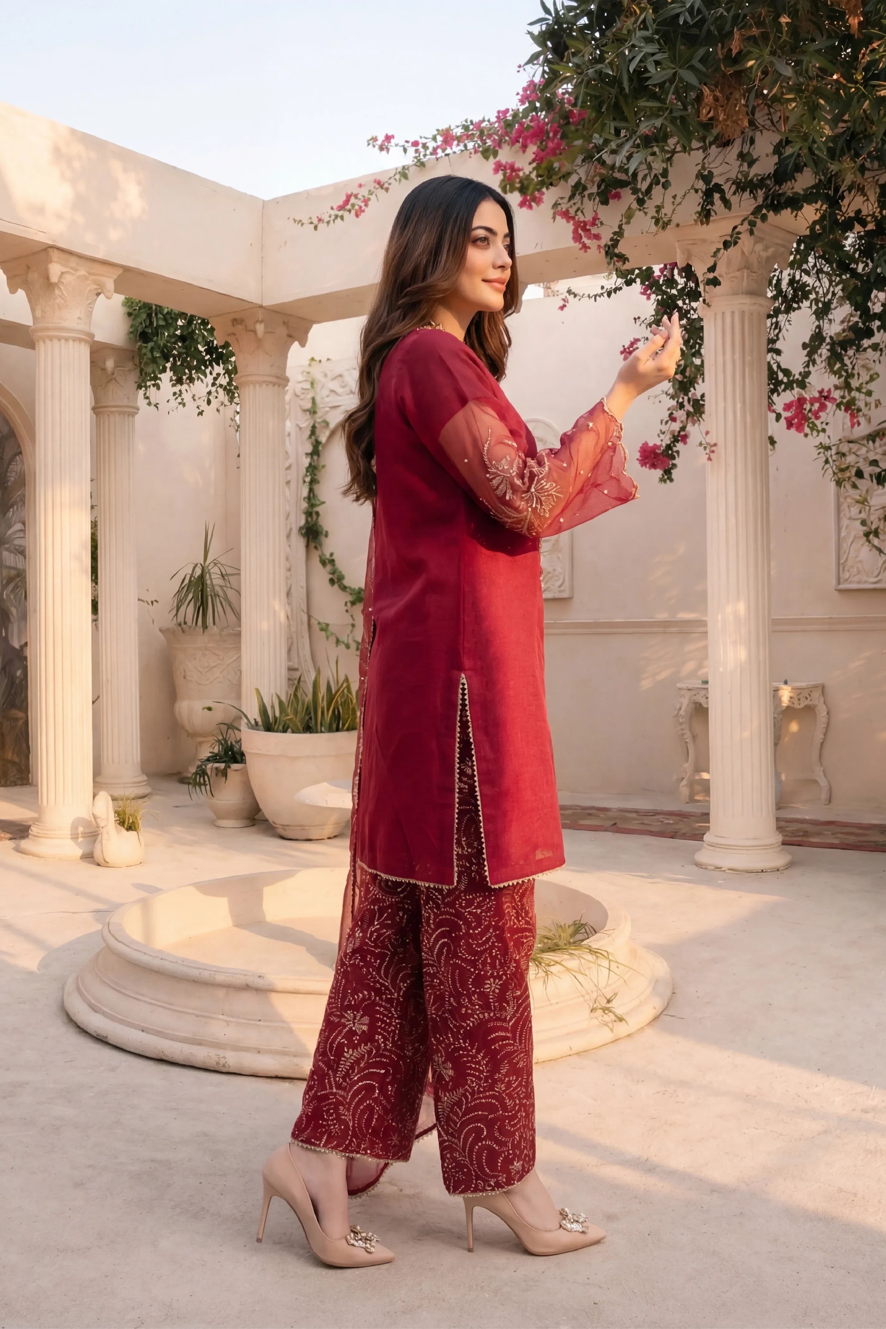 Elegant maroon embroidered Pakistani suit with sheer sleeves, perfect for formal occasions and weddings.