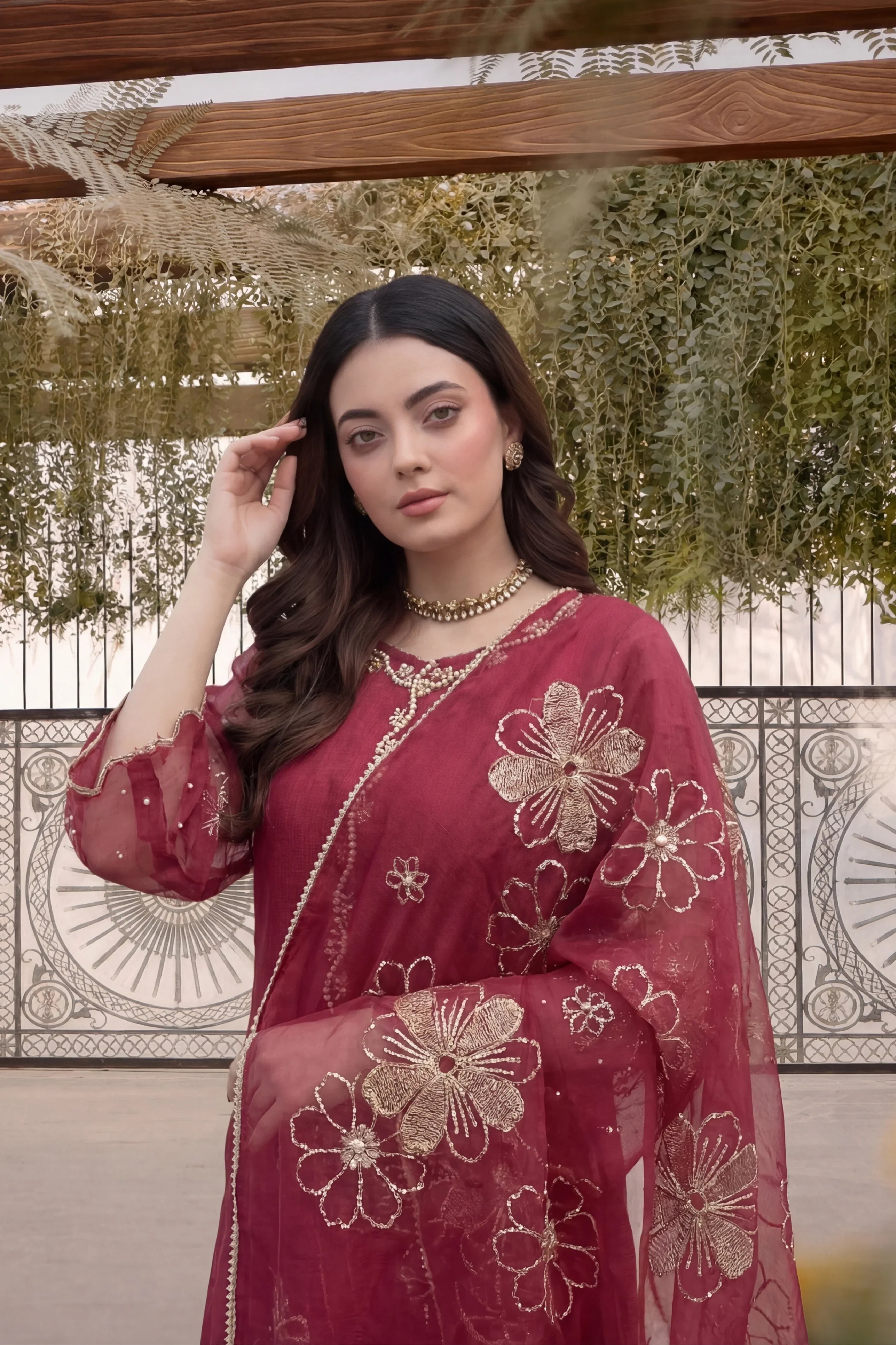 Elegant maroon Pakistani dress with gold floral embroidery, perfect for festive occasions and formal events.