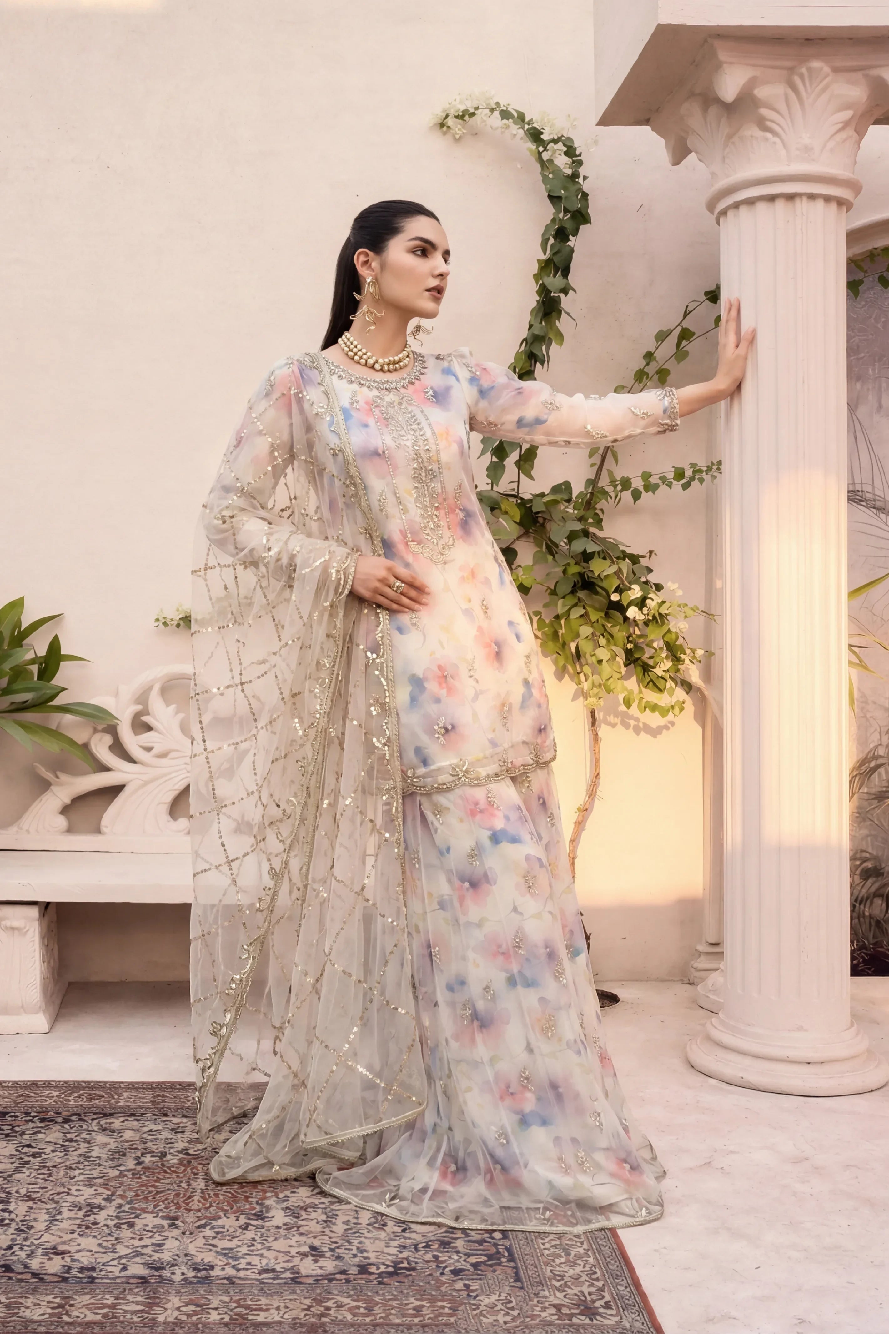 Elegant floral embroidered dress with gold detailing, perfect for special occasions in Pakistan.