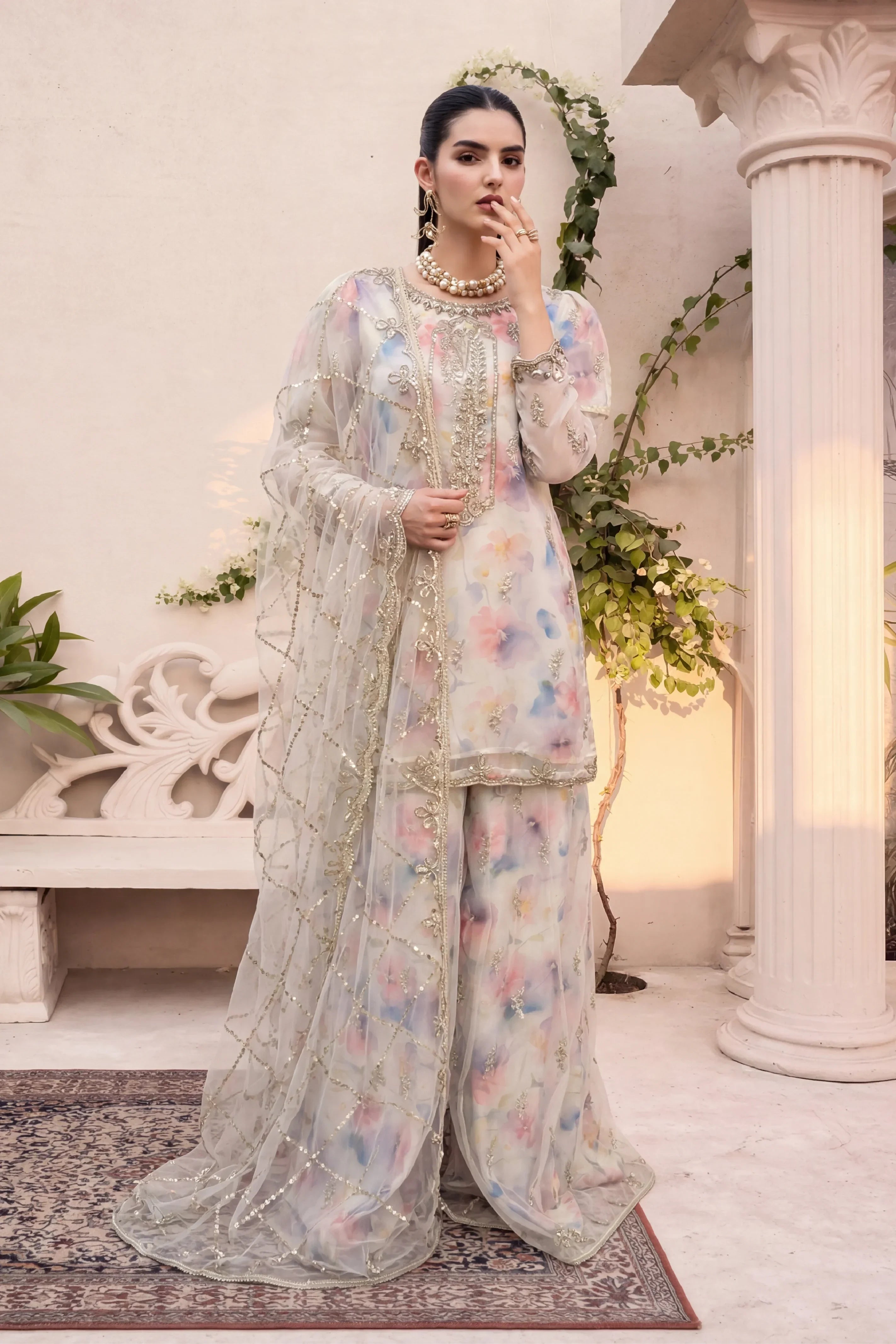 Elegant floral embroidered Pakistani suit with gold detailing, perfect for weddings and formal events.