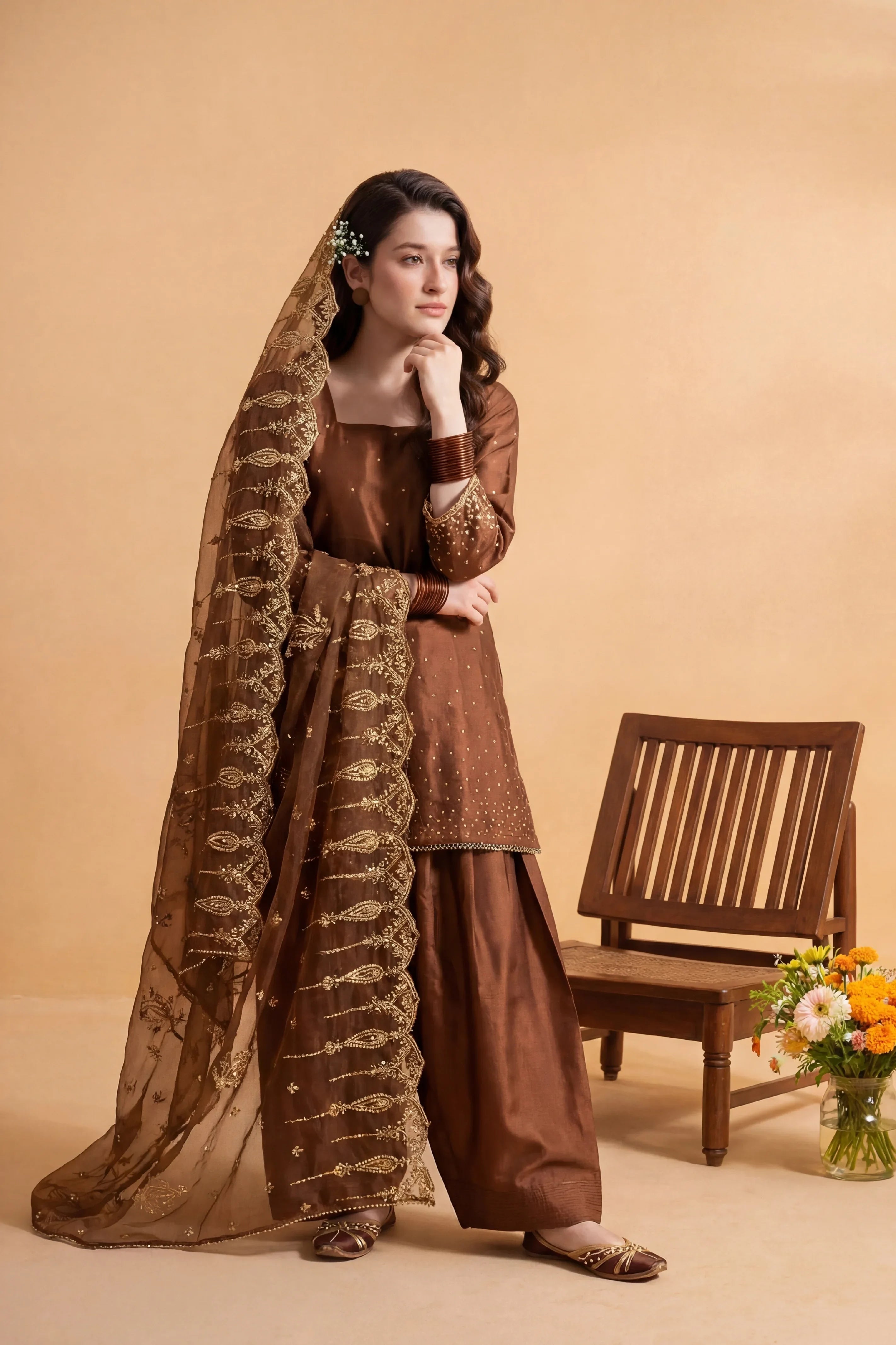 Elegant brown embroidered Pakistani dress with gold detailing, perfect for festive occasions and weddings.