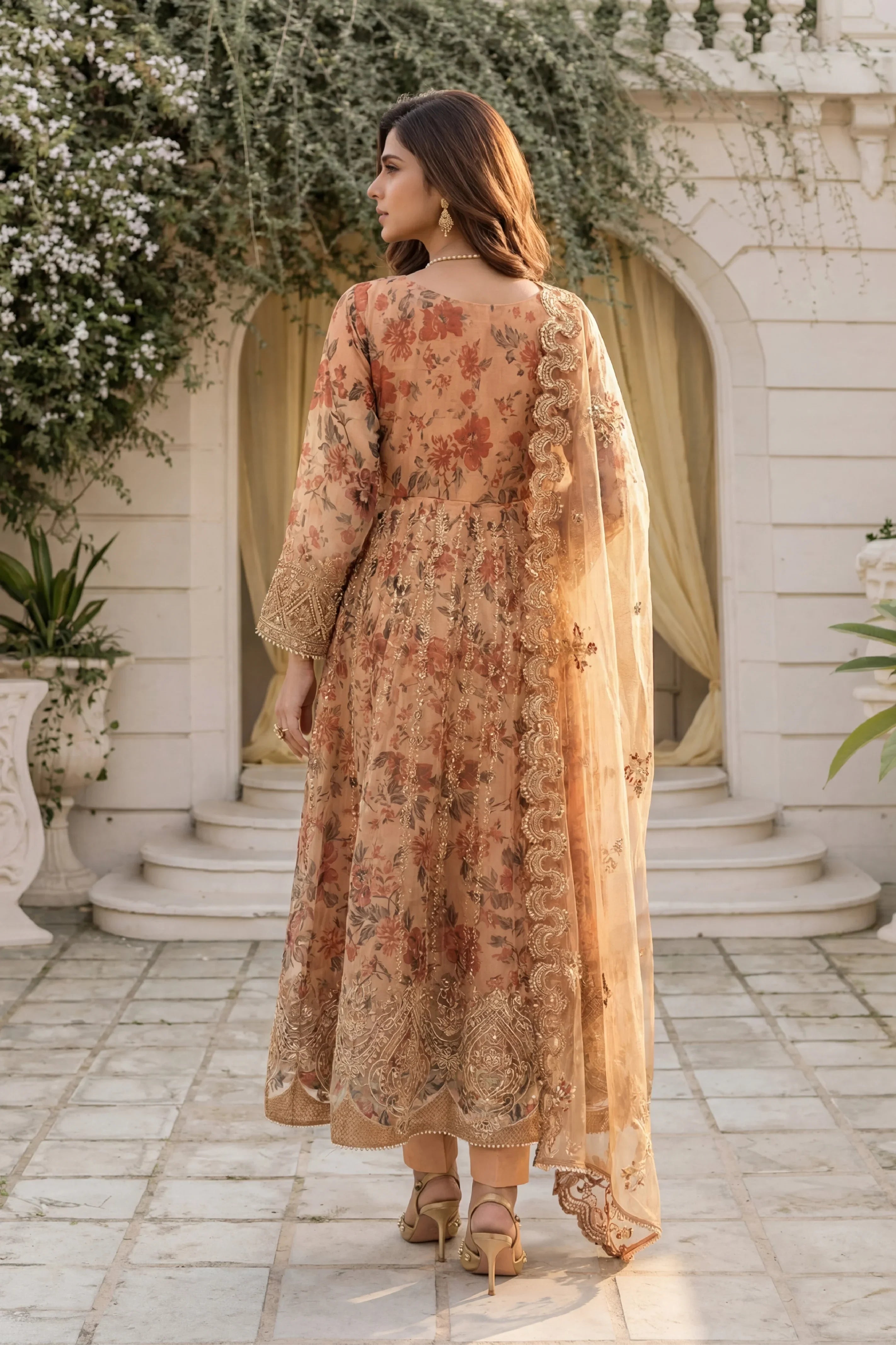 Elegant floral printed Pakistani suit with gold embroidery, perfect for formal occasions and weddings.