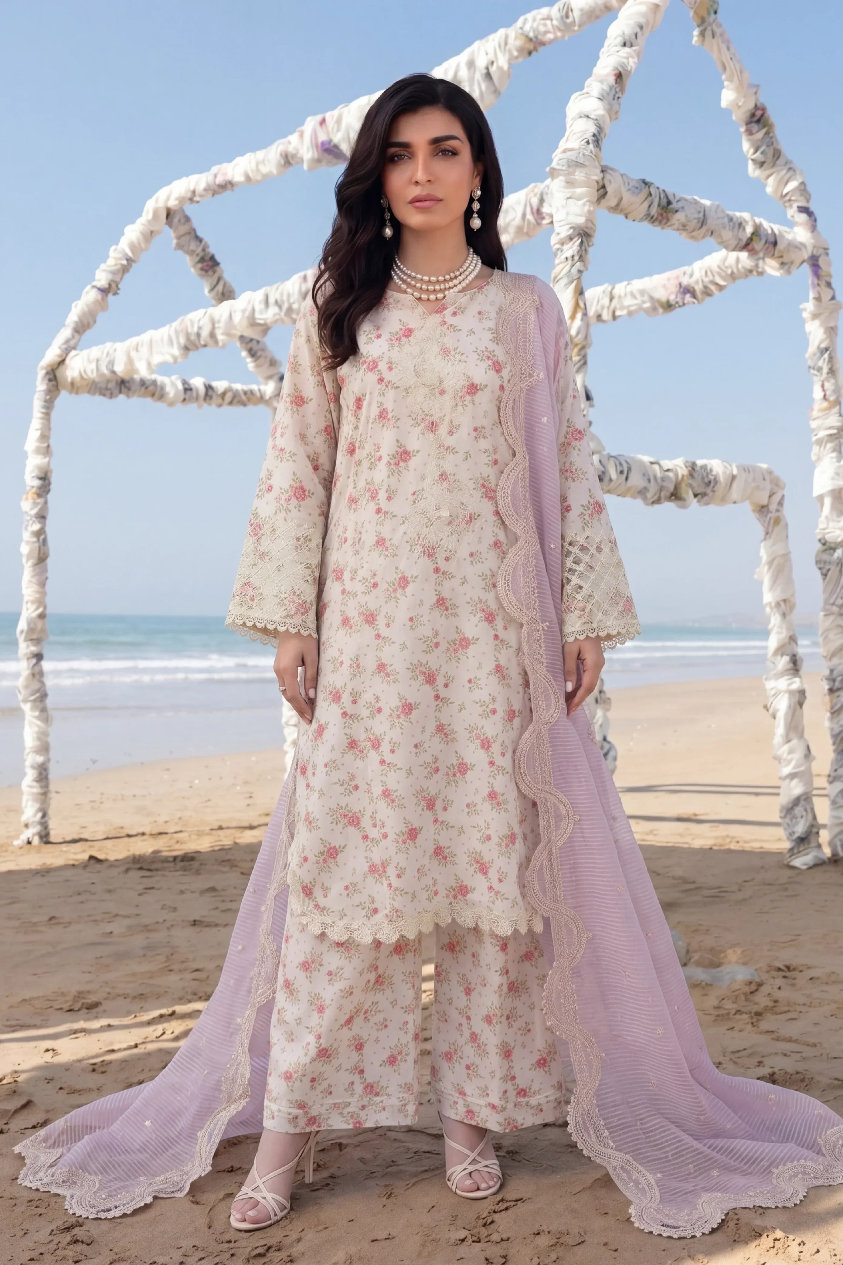 Floral printed stitched dress with lace detailing and lavender dupatta, beach setting