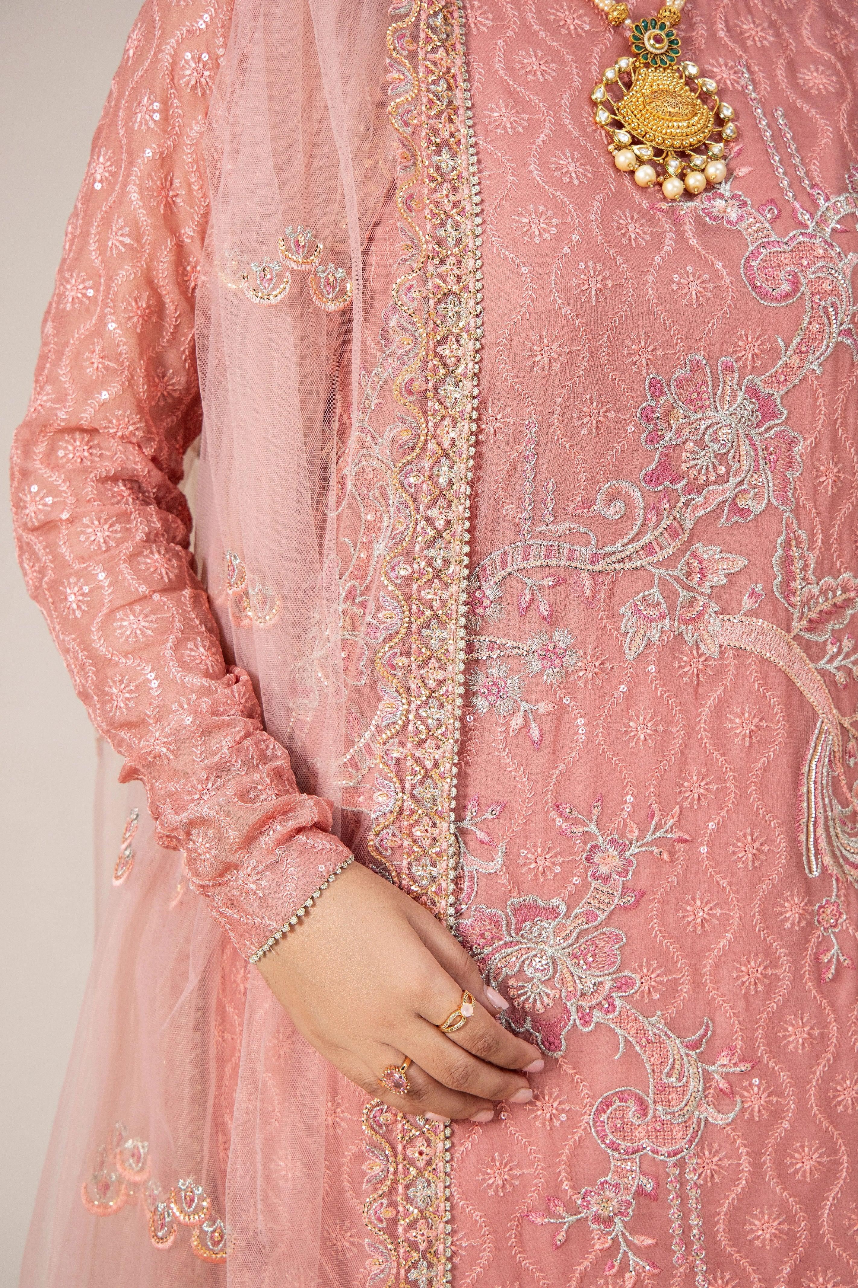 Pink embroidered Pakistani dress with gold detailing, tulle dupatta, and traditional jewelry for women&