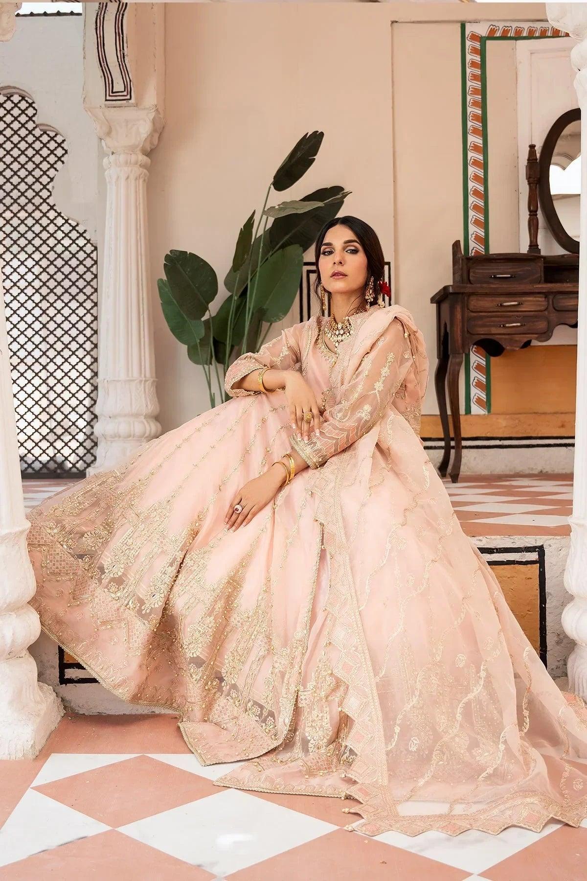 Elegant pink embroidered bridal dress with gold detailing, perfect for weddings and special occasions in Pakistan.