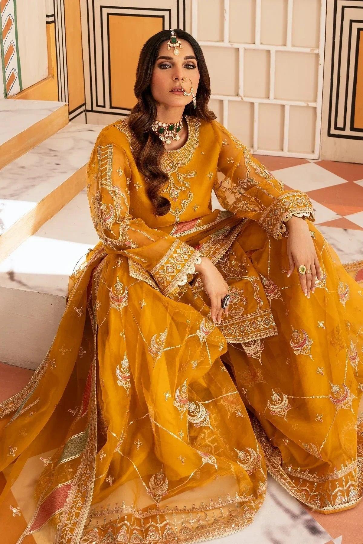 Elegant mustard yellow embroidered Pakistani dress with intricate gold detailing, perfect for weddings and special occasions.