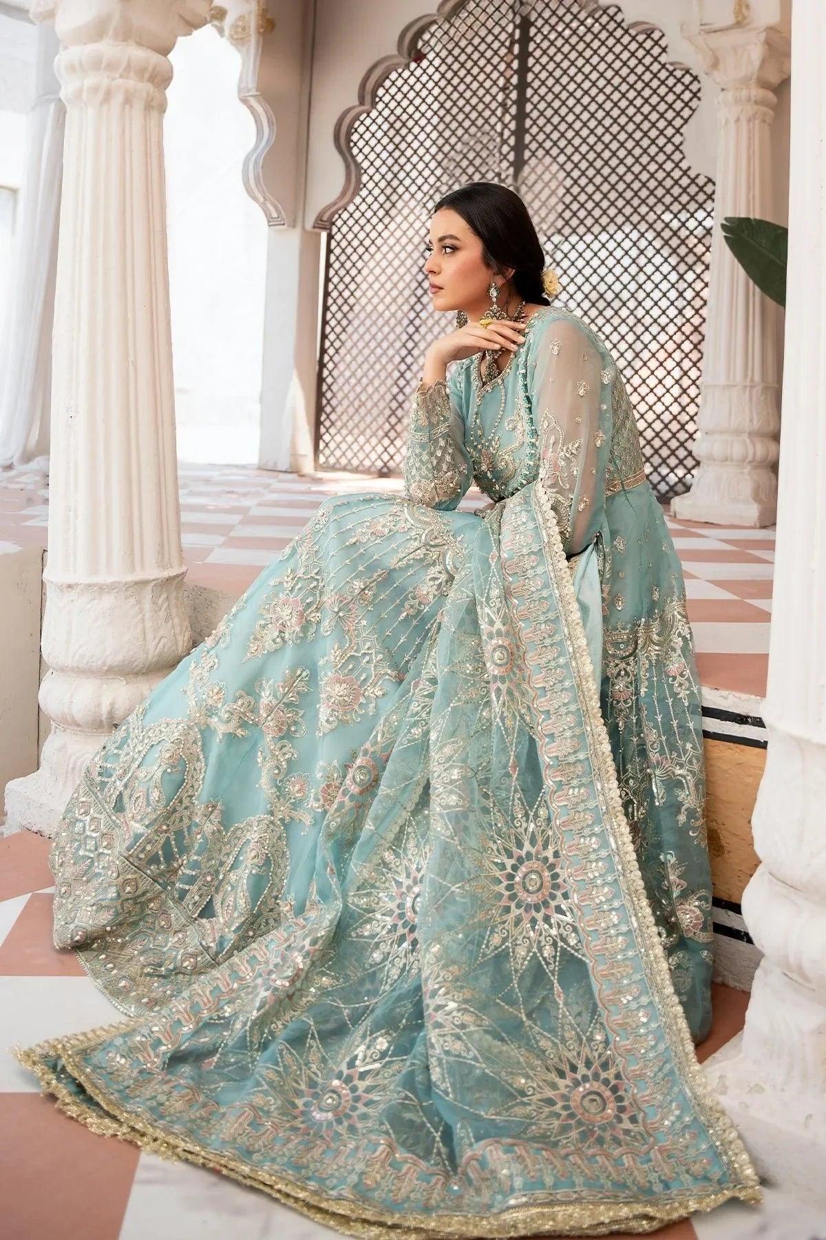 Elegant mint green embroidered Pakistani dress with gold detailing, perfect for weddings and formal events.