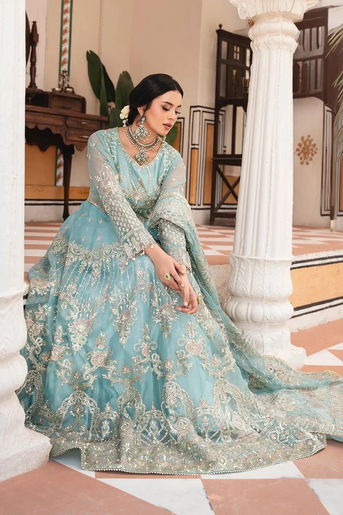 Elegant light blue embroidered Pakistani dress with intricate gold detailing, perfect for weddings and special occasions.