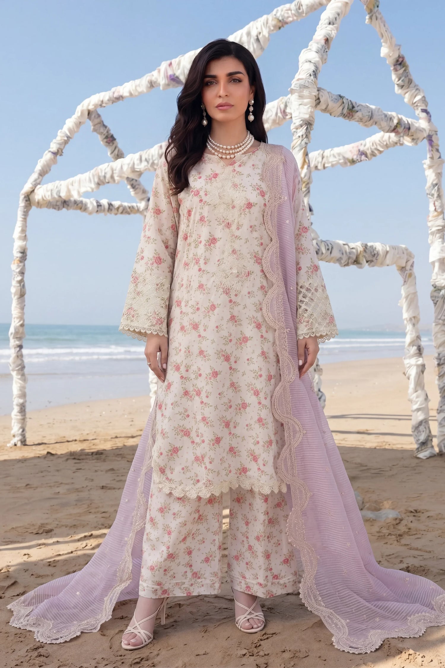 Floral printed stitched dress with lace detailing and lavender dupatta, beach setting
