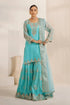 Elegant turquoise embroidered Pakistani suit with gold detailing, perfect for festive occasions and weddings.