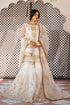 Elegant white embroidered Pakistani dress with gold detailing, perfect for weddings and formal occasions.
