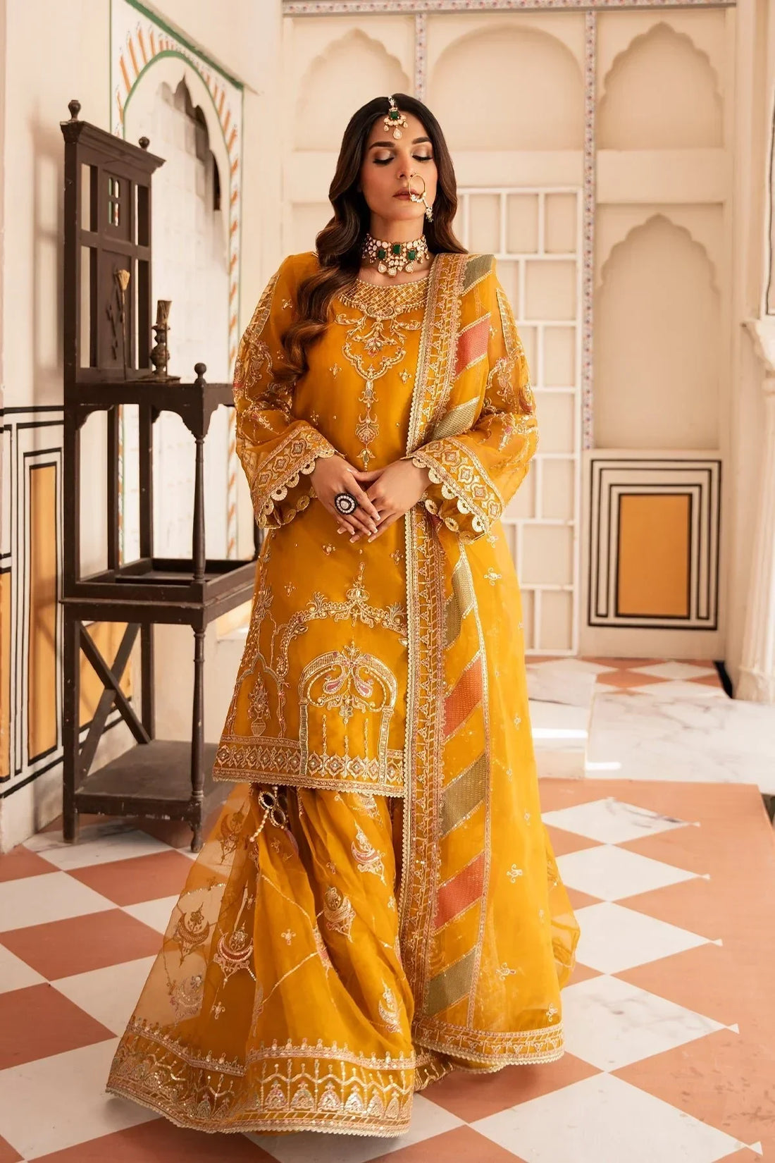 Elegant mustard yellow embroidered Pakistani dress with intricate gold detailing, perfect for festive occasions.