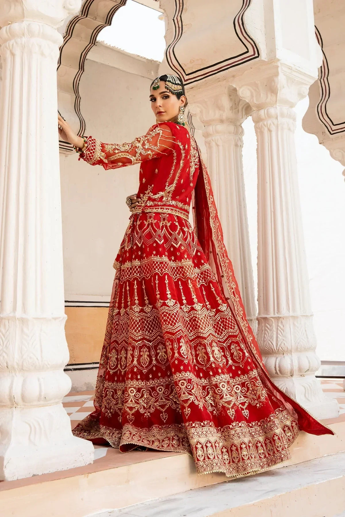 Red embroidered bridal lehenga with gold detailing, perfect for weddings and special occasions in Pakistan.